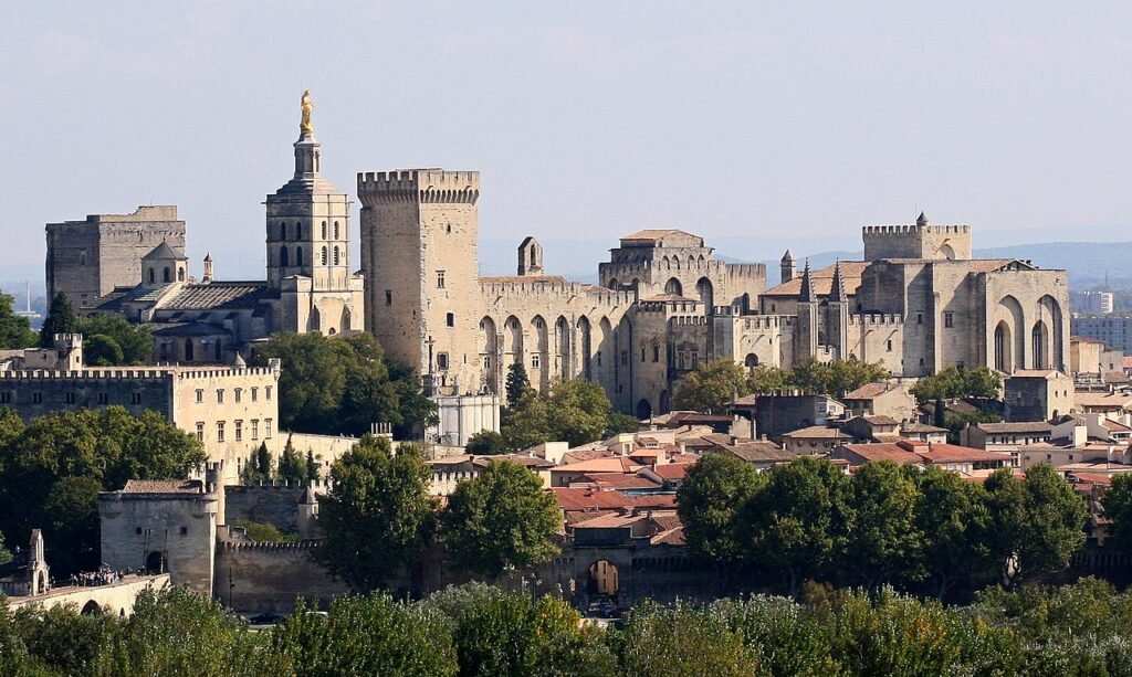 Avignon and Palais des Papes Source: https://commons.wikimedia.org/wiki/File:Avignon,_Palais_des_Papes_depuis_Tour_Philippe_le_Bel_by_JM_Rosier.jpg